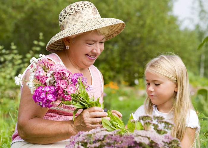 Grandmother and granddaughter collecting flowers